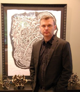 Joshua Harker in front of one of his Tangle drawings
